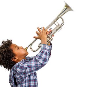 Young artist proudly plays the trumpet. Boy improvises on the trumpet. Trumpet playing the blues.